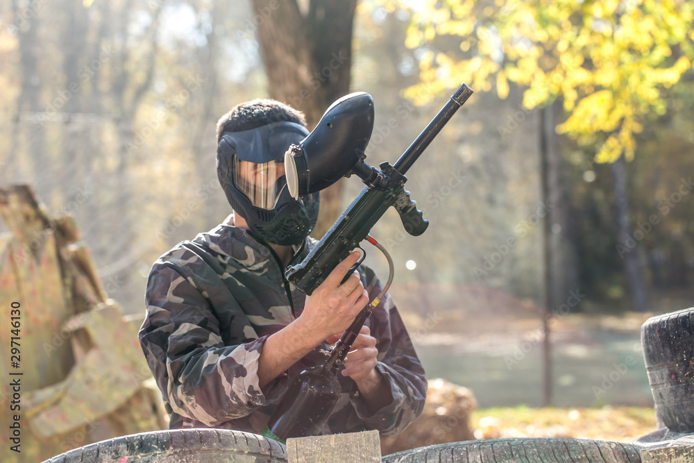 Fototapeta premium A man with a gun playing paintball.