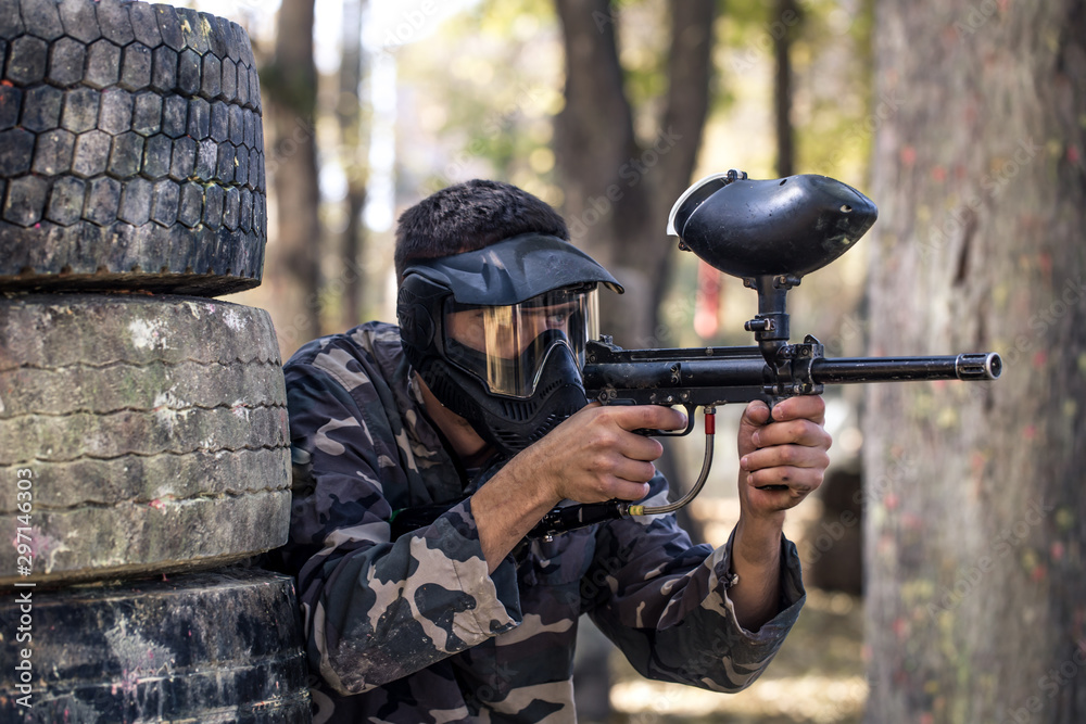 Fototapeta premium A man with a gun playing paintball.
