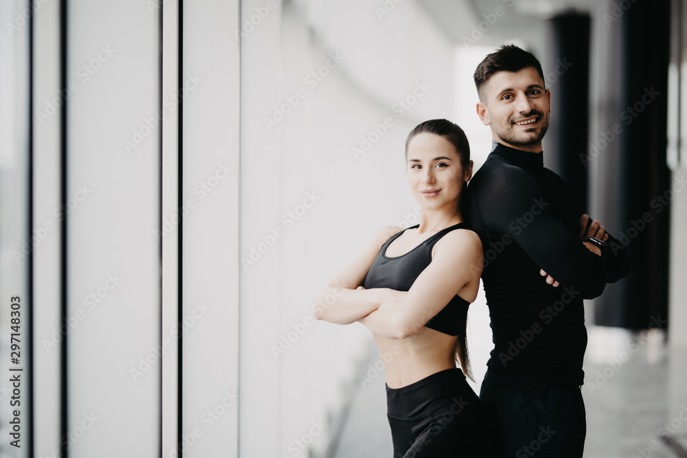 Sport, fitness, lifestyle and people concept - happy sportive man and woman at gym