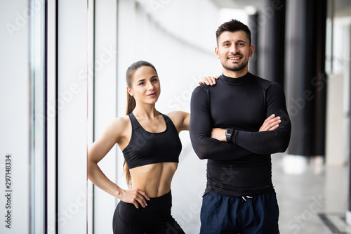 Portrait of a happy fit young couple with hands crossed in gym © F8  \ Suport Ukraine