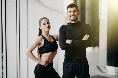 Sport, fitness, lifestyle and people concept - happy sportive man and woman at gym © F8  \ Suport Ukraine