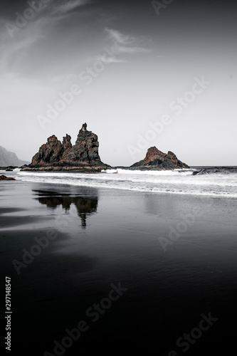 rock formations in the sea with reflections in the water