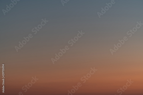 Orange horizon and blue atmosphere. Smooth orange blue gradient of dawn sky.