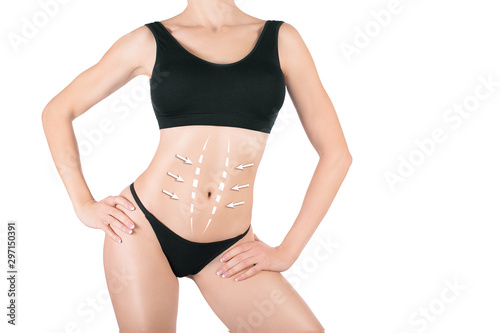 Female attractive body in black underwear. Lifting marking with arrows in womans belly, selective focus