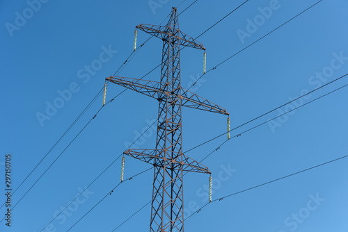 Power lines with various poles and supports, the appearance of an electrical transformer booth.