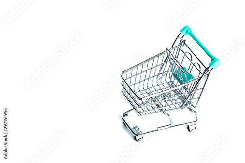 Miniature empty shopping cart turquoise color on white background. isolated. Top view, flat lay.