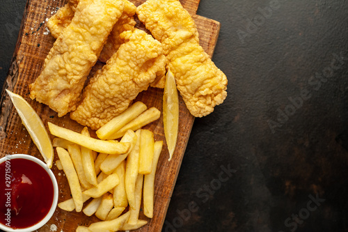fish and chips with french fries, on a stone background with copy space for your text
