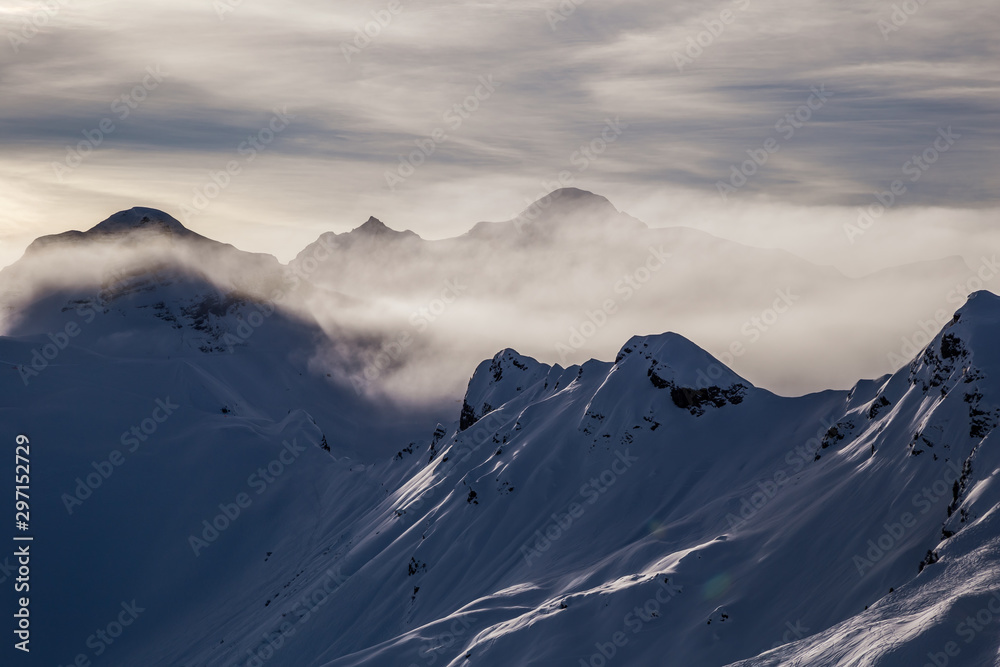 Mountains rising from the clouds before sunset Mountains rising from the clouds before sunset