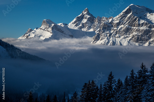 Inversion in valley and illuminated mountain peaks