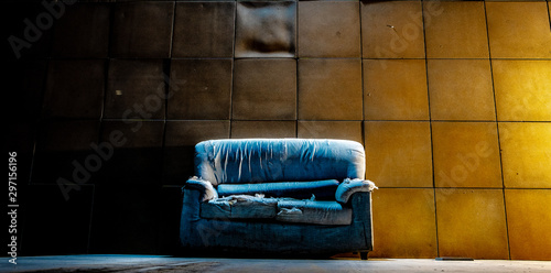 old abandoned sofa with light