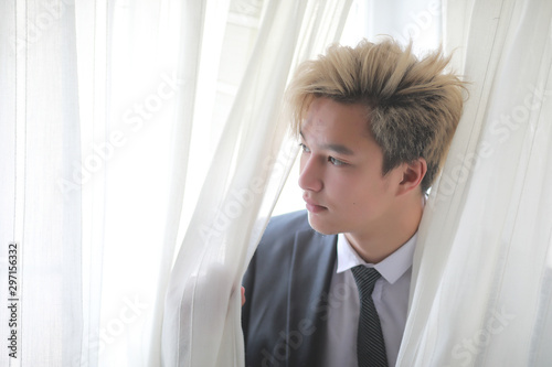 Young Asian businessman in white shirt and tie