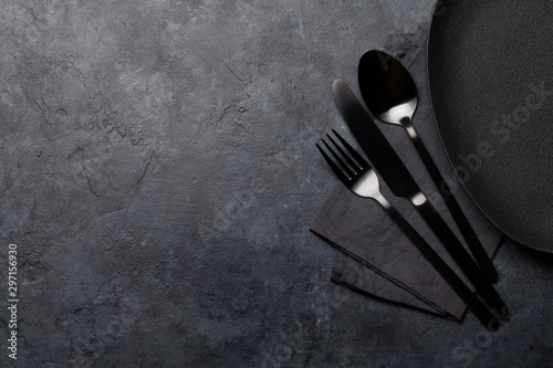 Empty plate, fork, spoon and knife