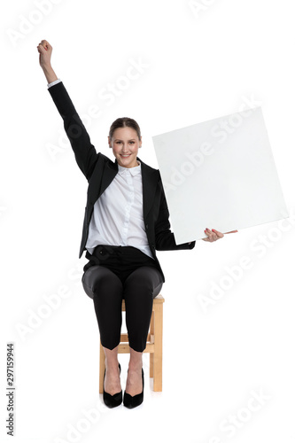 businesswoman holding billboard and one fist up