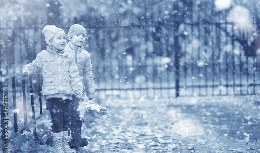 Kids walk in the park first snow Kids walk in the park first snow