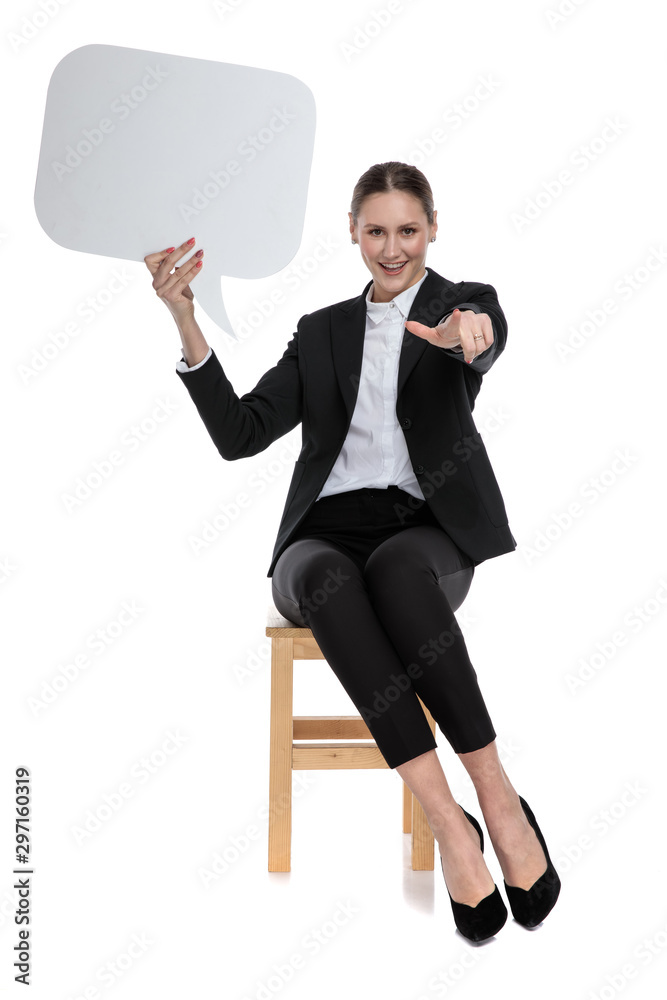 businesswoman holding speech bubble and pointing forward businesswoman holding speech bubble and pointing forward