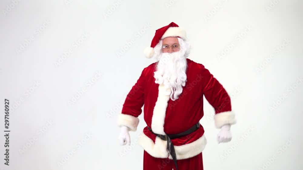 Christmas. Santa Claus on a white background wears black boxing gloves and fulfills punches. Kickboxing, fighter. He takes off his gloves and throws them. The training or battle is over. Christmas. Santa Claus on a white background wears black boxing gloves and fulfills punches. Kickboxing, fighter. He takes off his gloves and throws them. The training or battle is over.