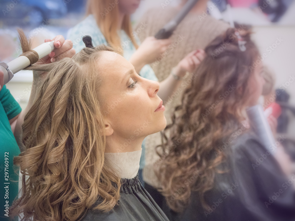 Fototapeta premium Curling curls, creating a beauty image. Toning. 