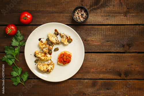 cauliflower grilled (fried grill vegetables or snack salad, bruschetta with tomato) menu concept. food background. copy space. Top view