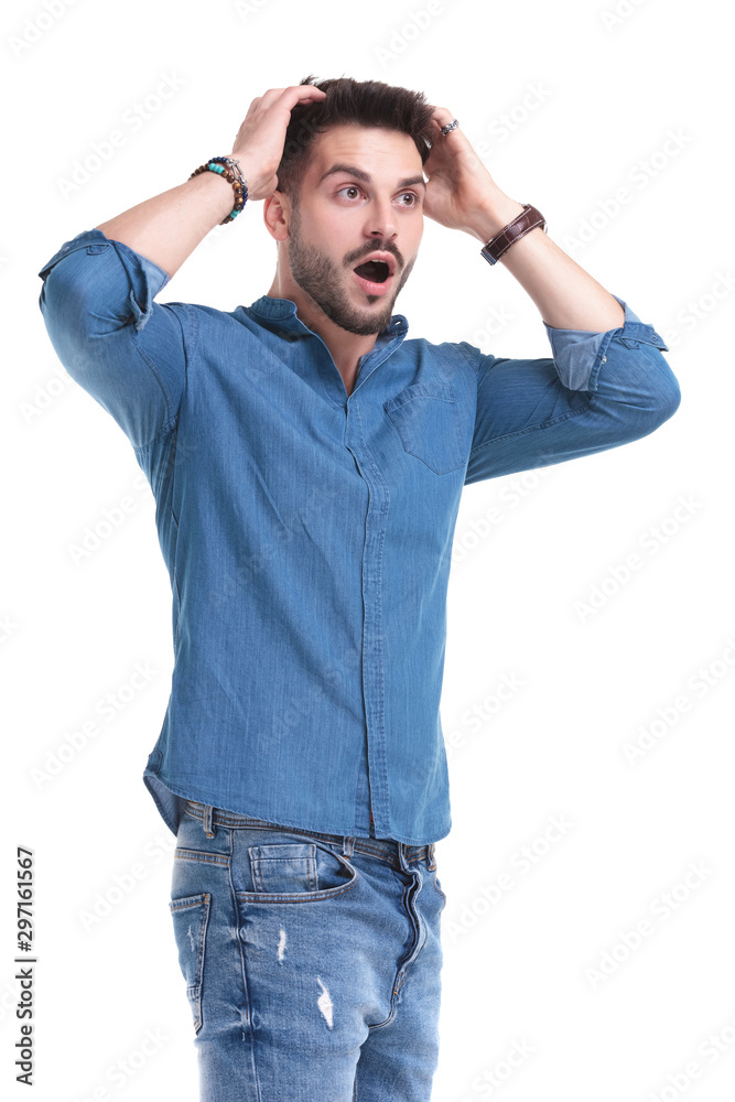 Amazed man looking away with his hands on his head Amazed man looking away with his hands on his head