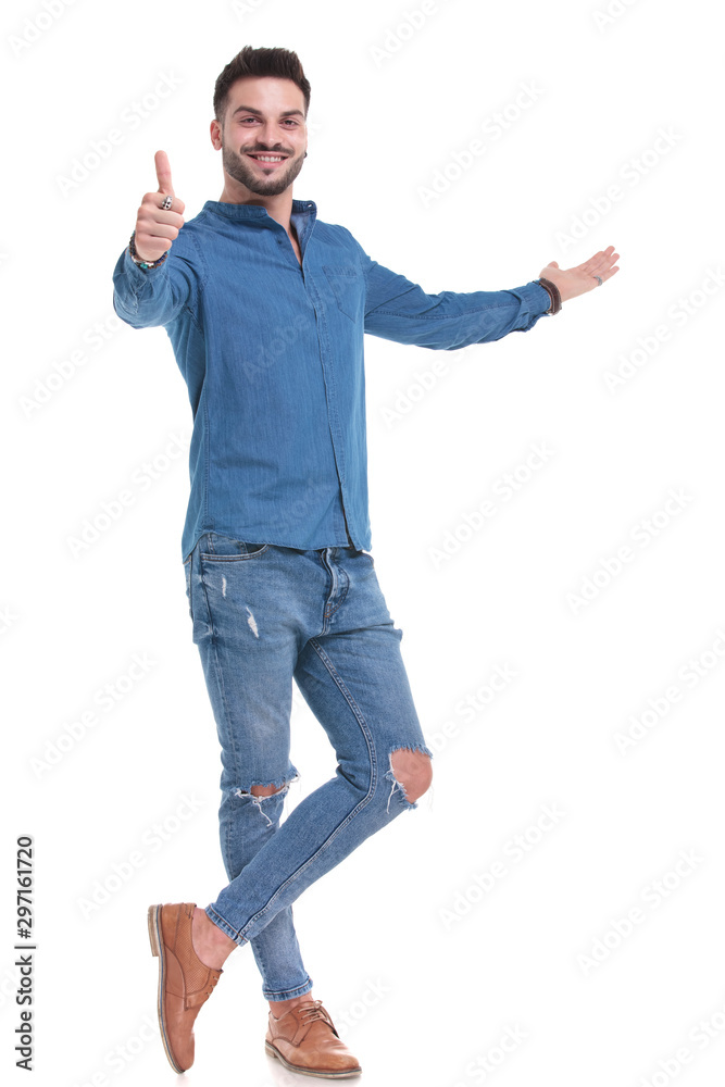 Handsome casual man giving a thumb up and presenting Handsome casual man giving a thumb up and presenting