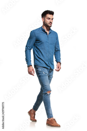 Motivated casual man walking to the side