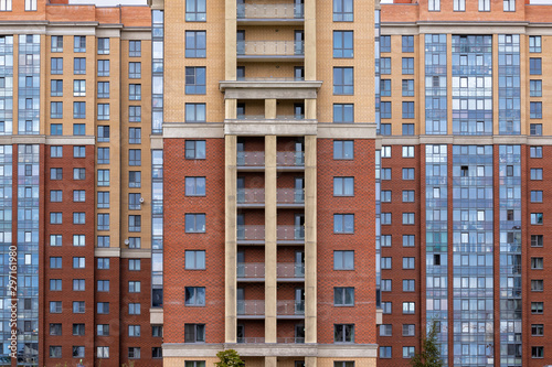 Modern architecture bright color facade high rise residential building front view.