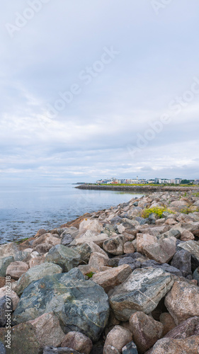 View of Salthill village   beach on a beautiful summer day  with rocks in the foreground. Near Galway Ireland