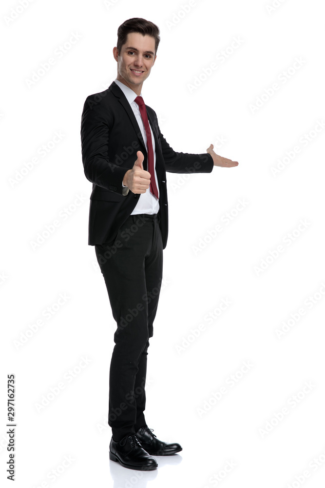 Positive young businessman showing and giving a thumbs up Positive young businessman showing and giving a thumbs up