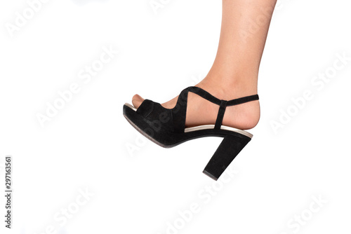 Female feet in black high heel shoe isolated on white background.