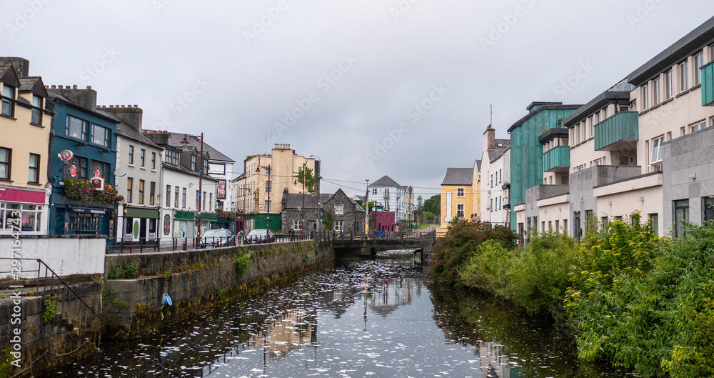 View of the River Corrib flowing through Galway City center with the old buildings.