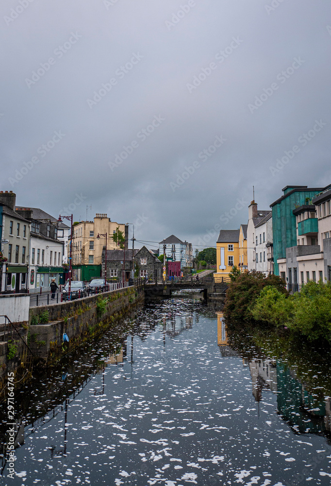View of the River Corrib flowing through Galway City center with the old buildings.