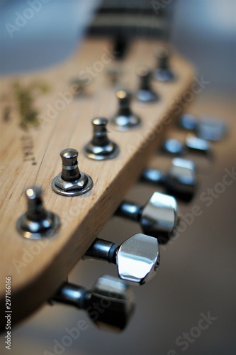 headstock of an e-guitar with chrome colored tuning machines closeup