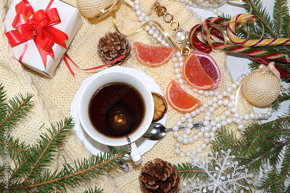 Christmas or New Year background with gift boxes and tea on the background of Christmas decorations, a warm woolen sweater, flat lay, top view, selective focus.Preparing for a happy congratulation, Christmas or New Year background with gift boxes and tea on the background of Christmas decorations, a warm woolen sweater, flat lay, top view, selective focus.Preparing for a happy congratulation,