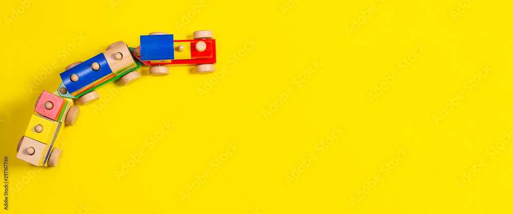 Wooden toy train with colorful blocks on yellow background - obrazy, fototapety, plakaty 