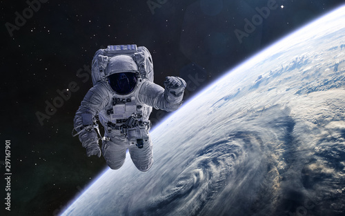 Fototapeta Naklejka Na Ścianę i Meble -  Astronaut on background of the Earth. Solar system. Science fiction. Elements of this image furnished by NASA