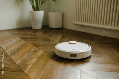robotic vacuum cleaner on laminate wood floor smart cleaning technology