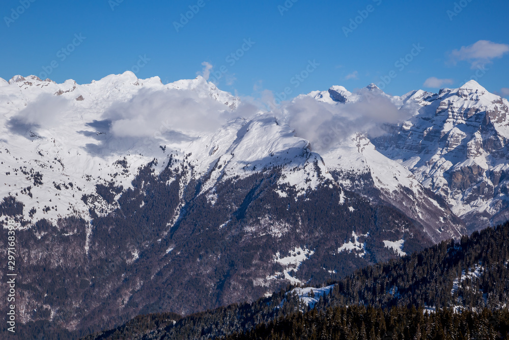 Panorama of winter Alps with low clouds