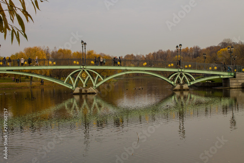 green iron bridge across the pond in Tsaritsyno Park autumn day in Moscow Russia