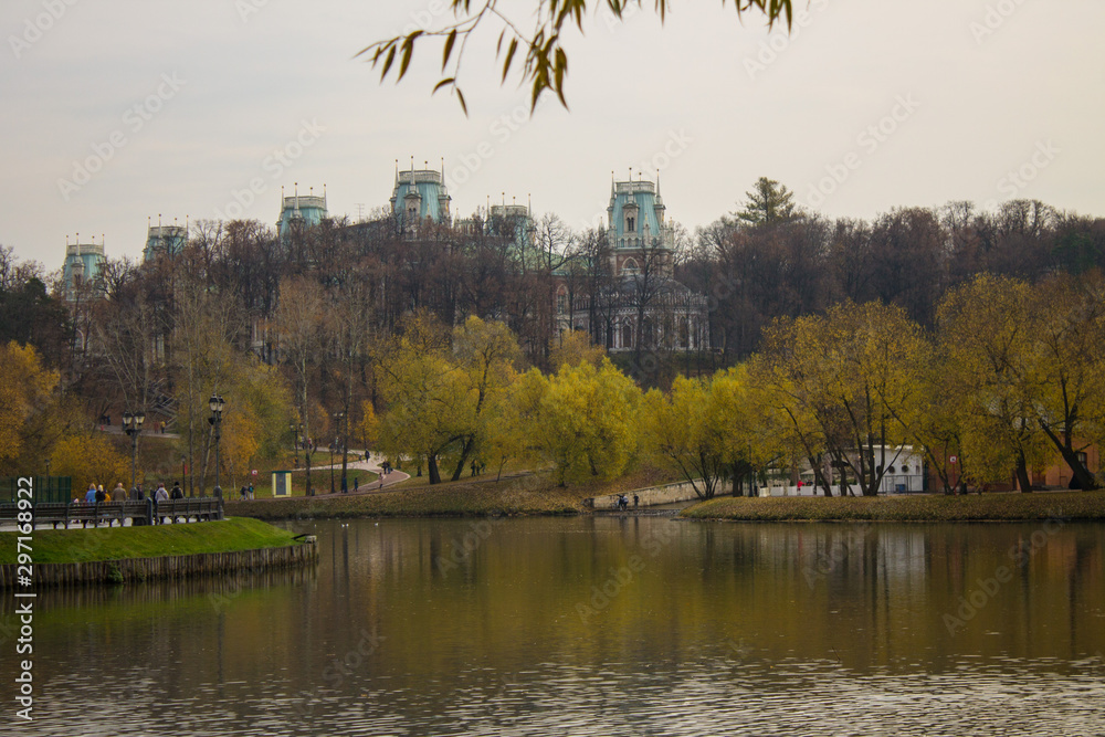Fototapeta premium Autumn landscape in the Tsaritsyno Park on the pond among the yellowed trees in Moscow Russia