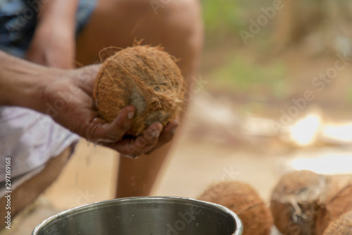 Cropped Hand Of Man Holding Coconut