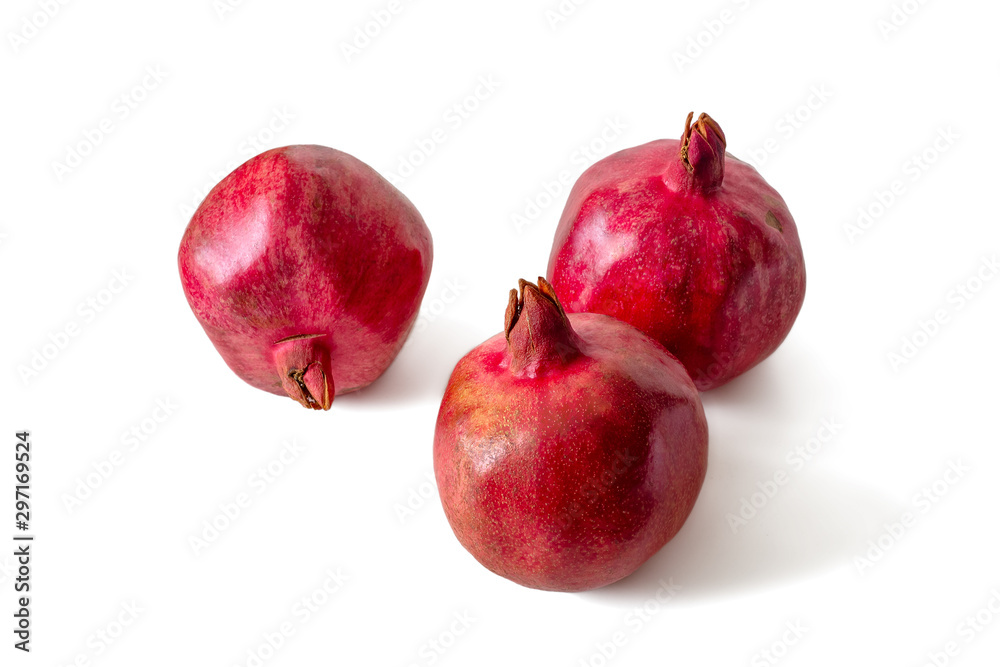 Three dark red pomegranates on a white background Three dark red pomegranates on a white background