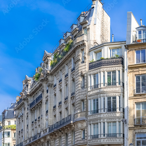 Paris, beautiful facade in a chic area, typical balcony and windows