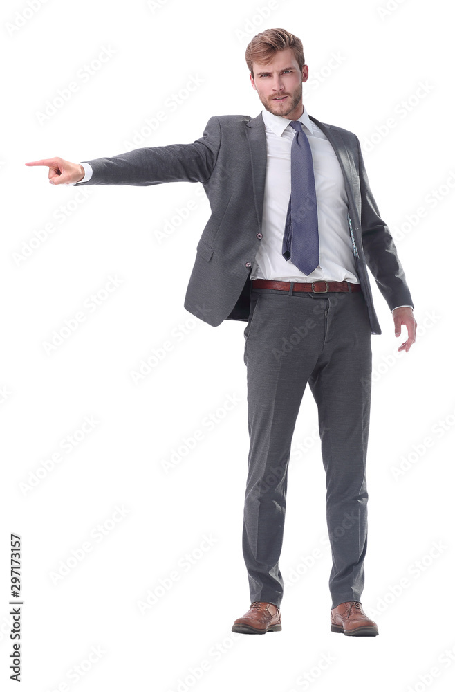 in full growth. serious businessman pointing to the side. in full growth. serious businessman pointing to the side.