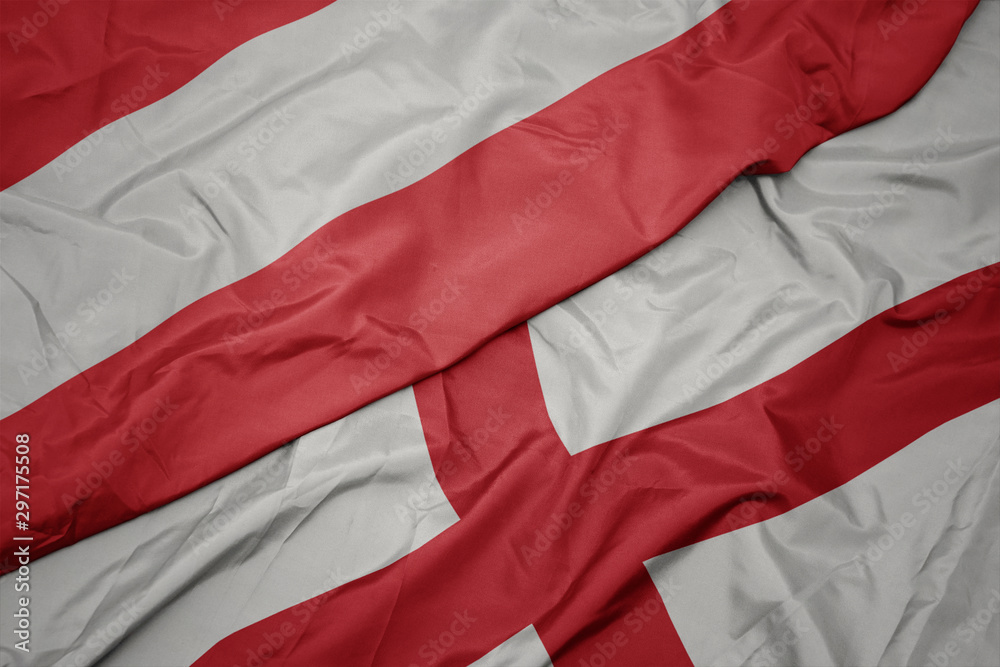 waving colorful flag of england and national flag of austria. waving colorful flag of england and national flag of austria.