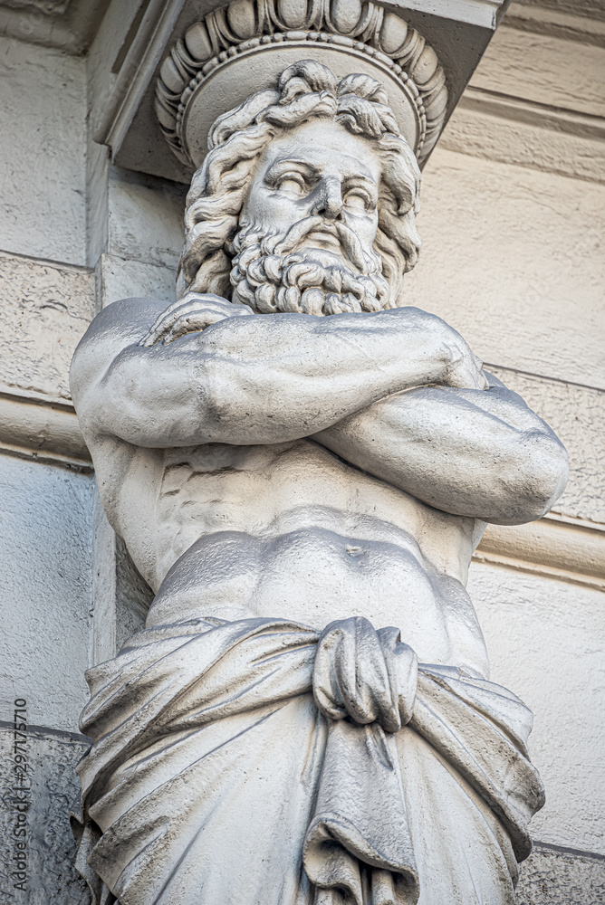 Statue of powerful and emotional atlas of Renaissance Era as support for building facade in Vienna, Austria, details, closeup
