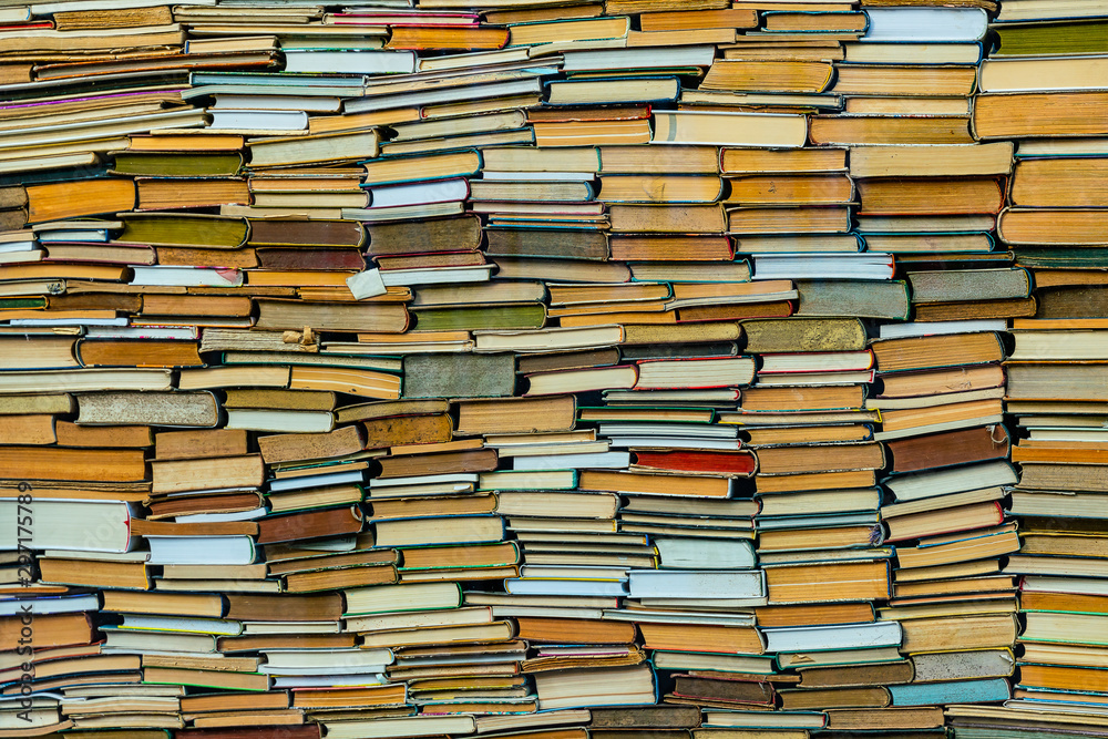A huge amount of stacked old books. Wall of books. A huge amount of stacked old books. Wall of books.