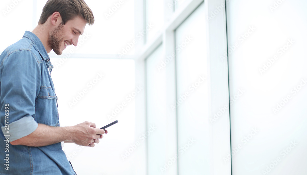 young businessman choosing a contact in his smartphone.