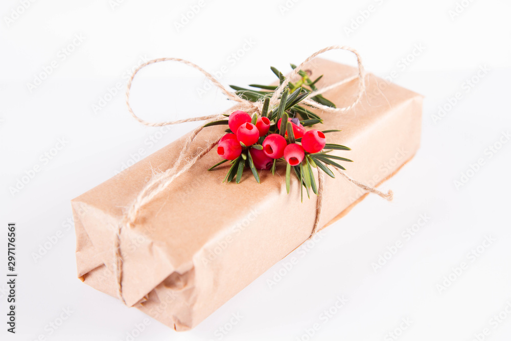 Gift decorated with a gunny string bow and with a common yew twig Gift decorated with a gunny string bow and with a common yew twig