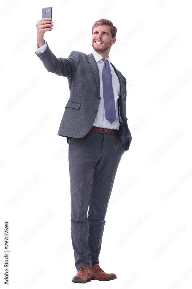 in full growth. smiling businessman taking selfie. in full growth. smiling businessman taking selfie.