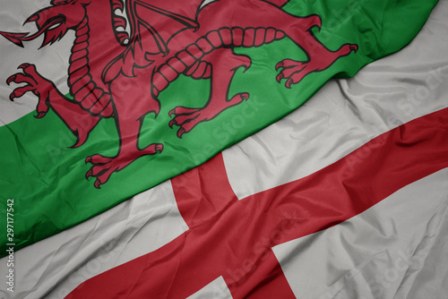 Fotografija waving colorful flag of england and national flag of wales.